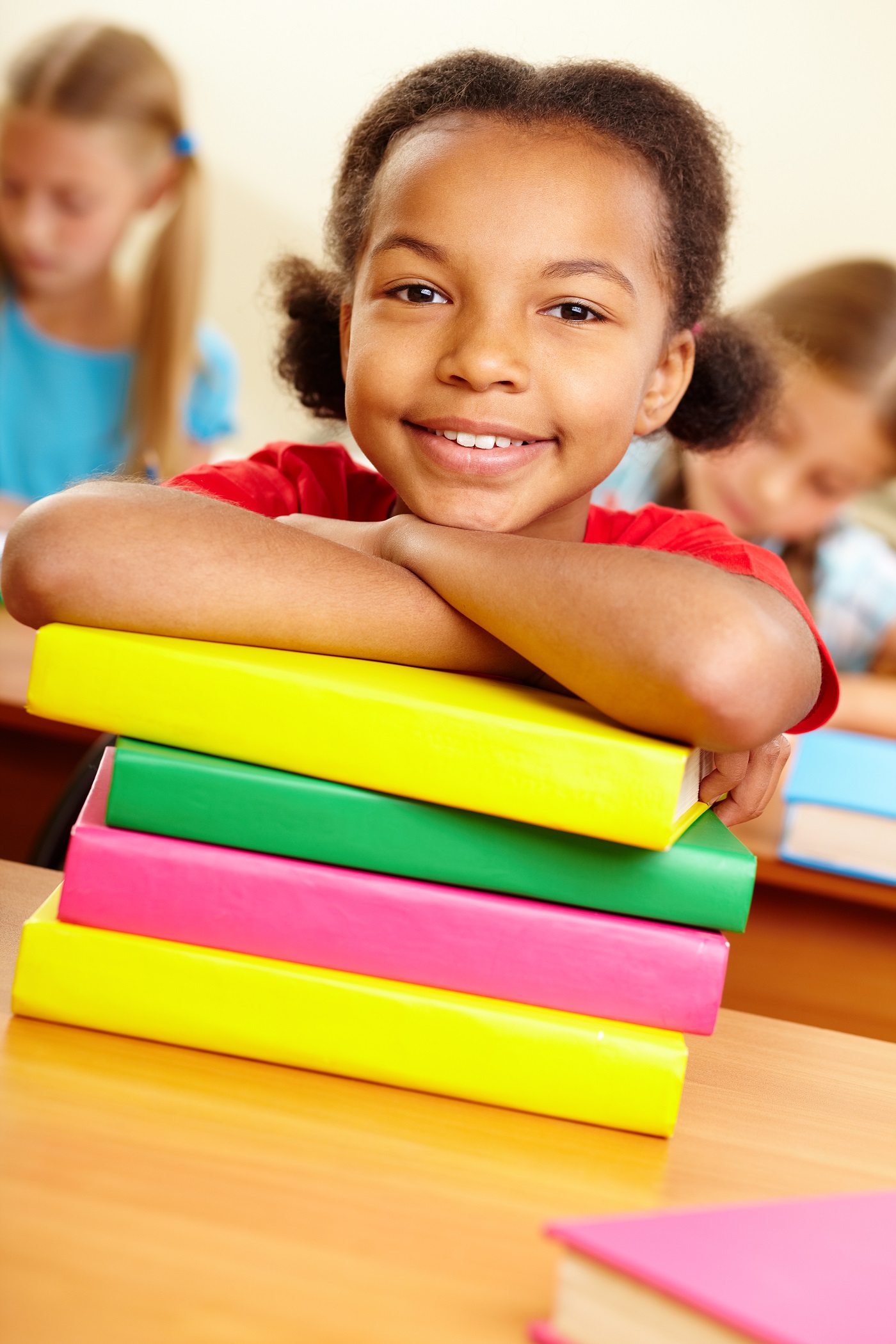 little girl with colorful books table